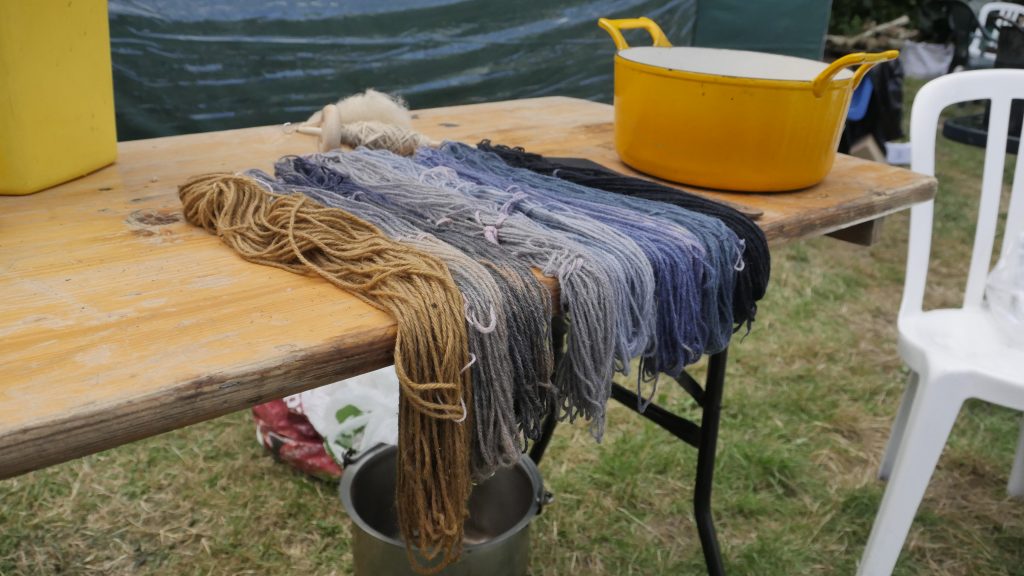 Spinning and Dyeing Threads hanging over a table edge to dry.