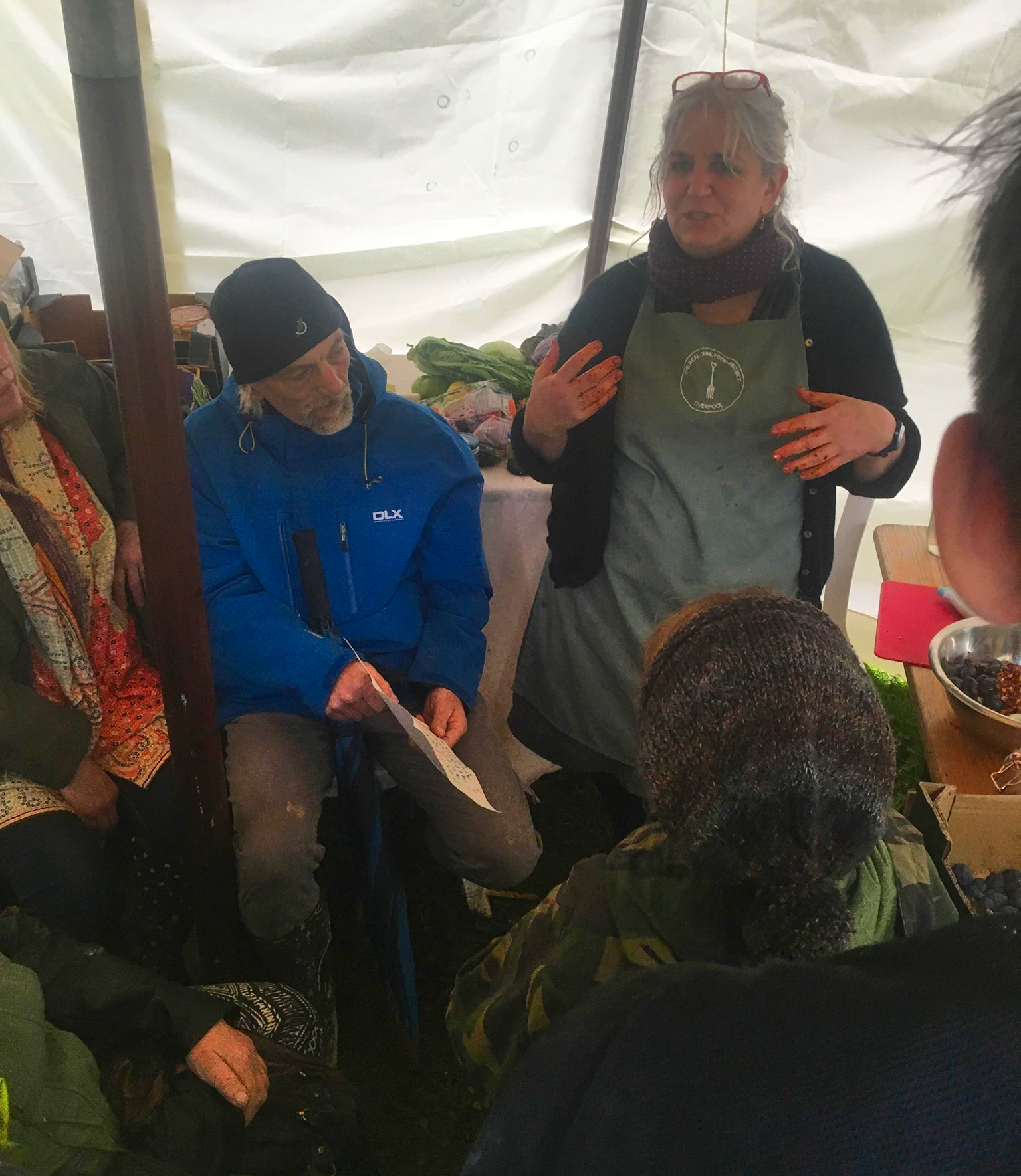 Annie Levy teaching basic fermenting skills surrounded by people in a small marquee