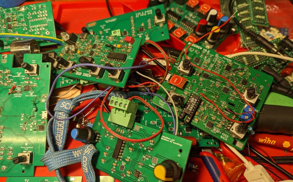 a pile of old PCBs - previous versions of our dub siren